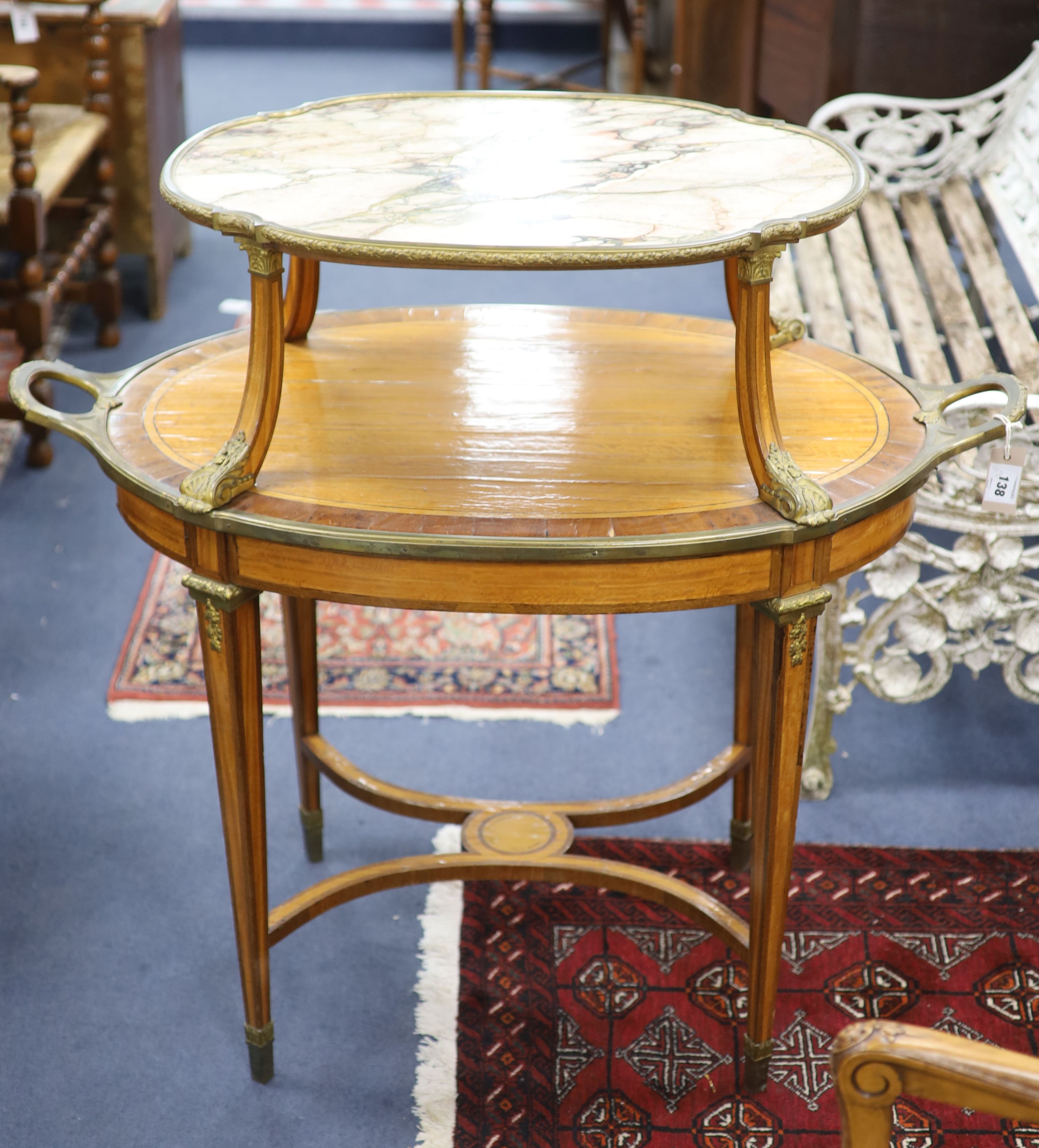 A late 19th century French satinwood, rosewood crossbanded and gilt metal mounted two tier oval etagere,